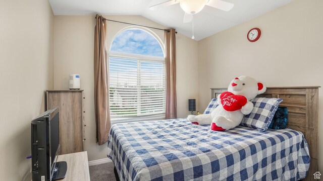 carpeted bedroom featuring lofted ceiling, baseboards, and ceiling fan