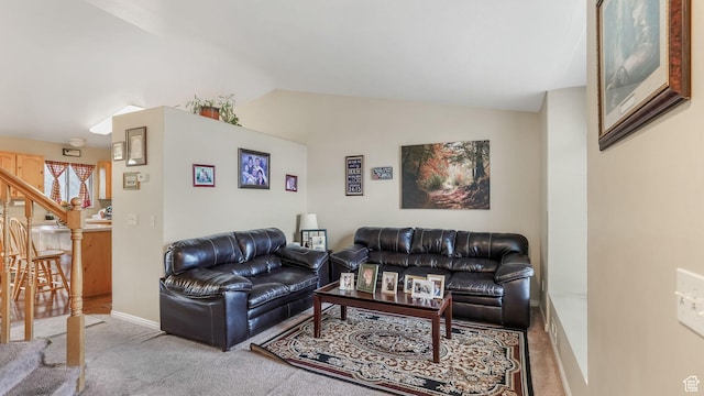living area featuring vaulted ceiling, baseboards, carpet floors, and stairs