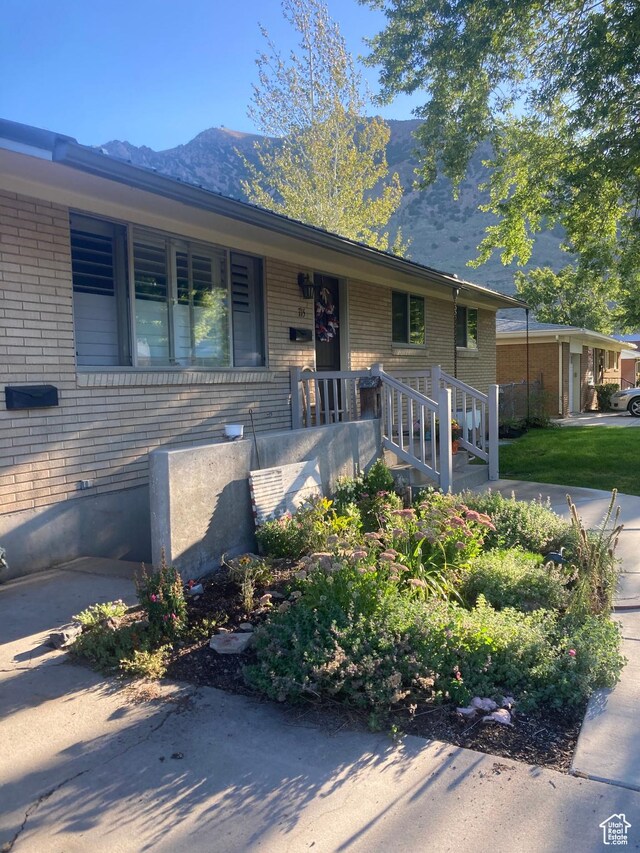 715 Oak Dr, Brigham City, UT 84302 - view of front of house featuring brick siding and a mountain view
