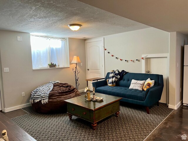 715 Oak Dr, Brigham City, UT 84302 - living area featuring baseboards and a textured ceiling