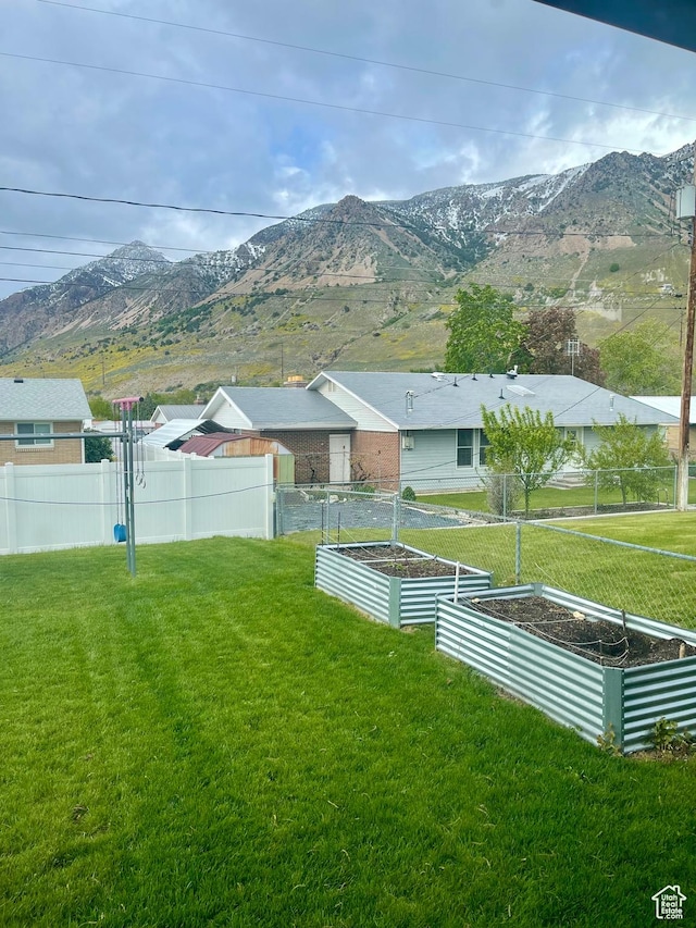 715 Oak Dr, Brigham City, UT 84302 - view of yard with a garden, fence, and a mountain view