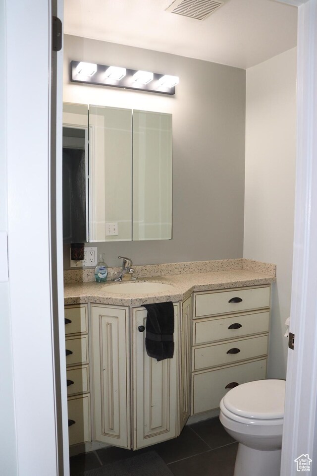 715 Oak Dr, Brigham City, UT 84302 - bathroom with toilet, vanity, tile patterned floors, and visible vents