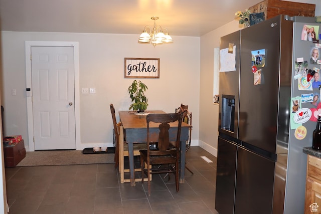 715 Oak Dr, Brigham City, UT 84302 - dining space featuring dark tile patterned flooring, baseboards, and a notable chandelier