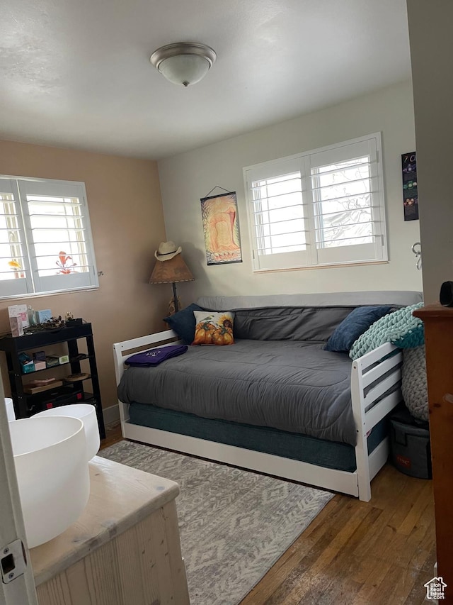 715 Oak Dr, Brigham City, UT 84302 - bedroom with wood finished floors and multiple windows