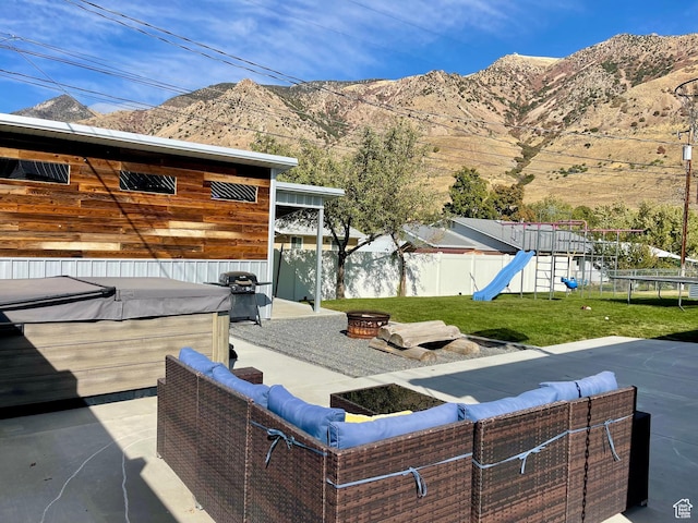 715 Oak Dr, Brigham City, UT 84302 - view of patio / terrace with a playground, a fenced backyard, grilling area, a hot tub, and a mountain view