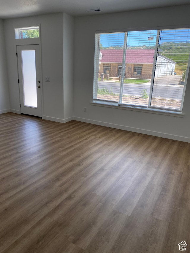 foyer entrance with dark wood finished floors and baseboards