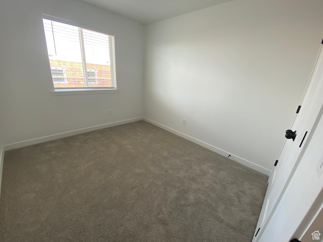 spare room with carpet floors and baseboards