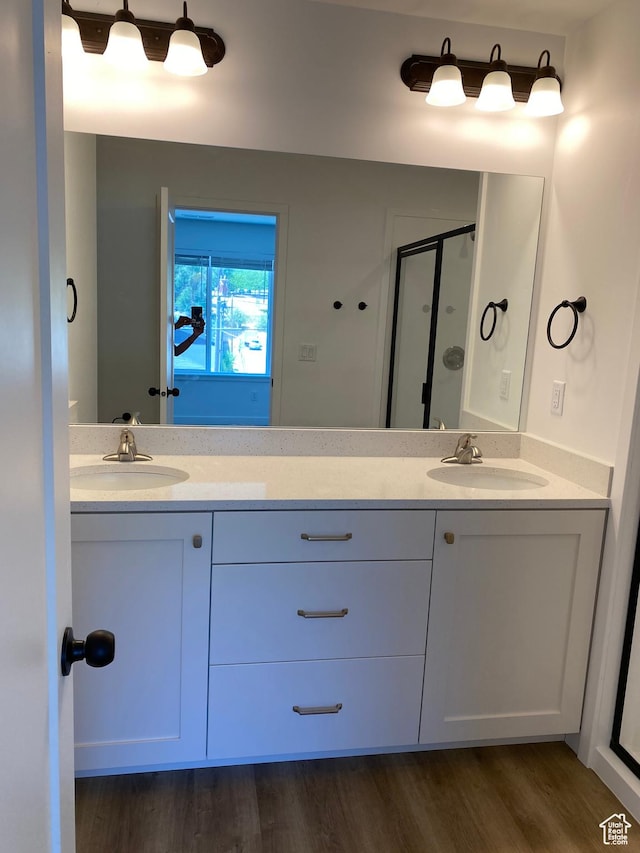 full bathroom with a sink, double vanity, and a stall shower