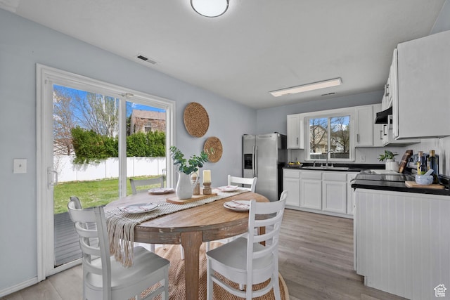 718 N 410 W, Tooele, UT 84074 - dining room featuring light wood-style flooring and visible vents