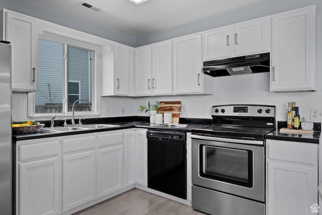 718 N 410 W, Tooele, UT 84074 - kitchen featuring under cabinet range hood, stainless steel appliances, dark countertops, visible vents, and a sink