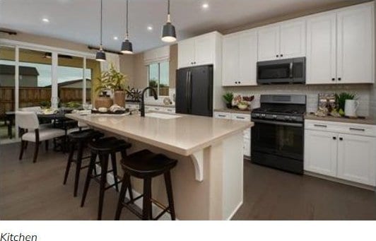 1111 W 450 S Unit 64, Brigham City, UT 84302 - kitchen with black appliances, a kitchen island with sink, backsplash, white cabinetry, and recessed lighting