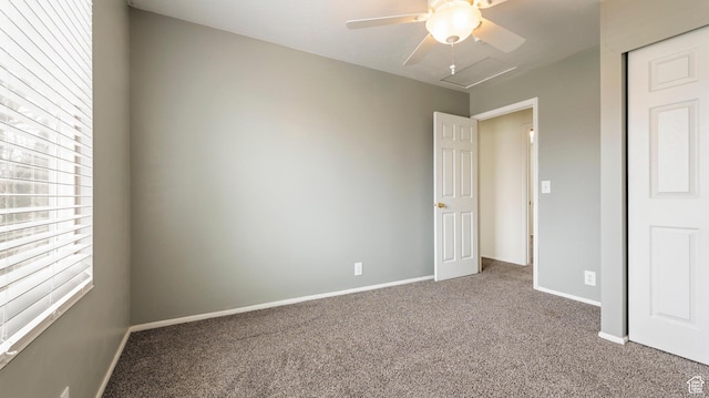 unfurnished bedroom featuring carpet floors, baseboards, and ceiling fan