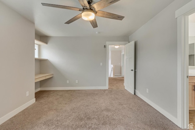 interior space with baseboards and a ceiling fan