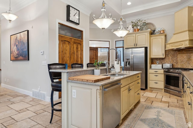 kitchen featuring stainless steel appliances, backsplash, visible vents, ornamental molding, and a sink