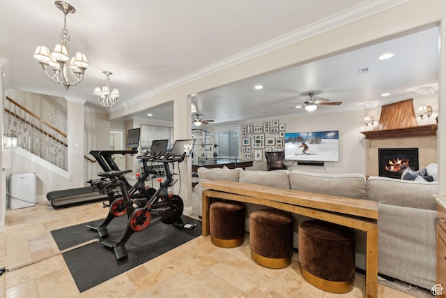 workout room featuring ceiling fan with notable chandelier, a large fireplace, recessed lighting, and crown molding