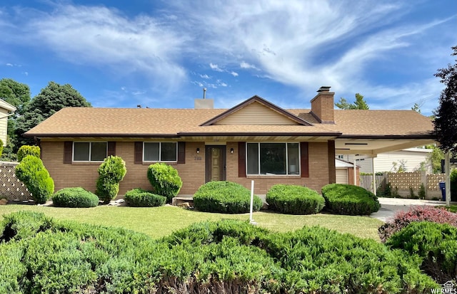 394 E Bridlewood Dr S, Salt Lake City, UT 84107 - ranch-style house featuring brick siding, a chimney, a front lawn, fence, and roof with shingles