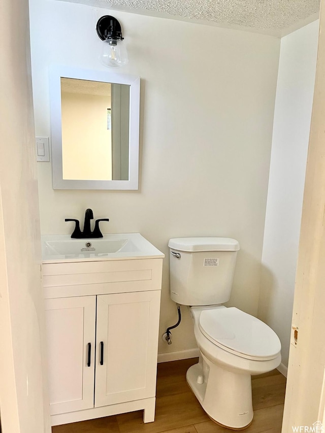 394 E Bridlewood Dr S, Salt Lake City, UT 84107 - bathroom featuring wood finished floors, vanity, toilet, and baseboards