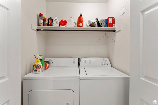 clothes washing area featuring washing machine and clothes dryer and laundry area