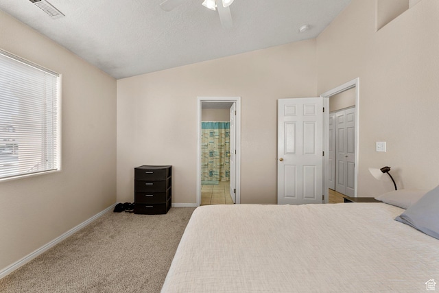 bedroom featuring a ceiling fan, carpet, baseboards, lofted ceiling, and visible vents