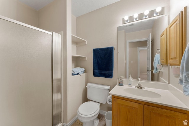 bathroom featuring vanity, tile patterned flooring, a shower stall, and toilet