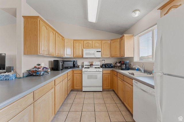 kitchen with vaulted ceiling, white appliances, a sink, and light brown cabinetry