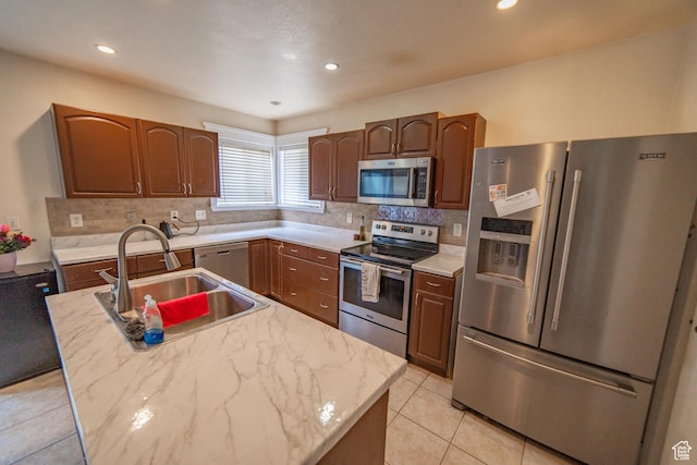 1137 S Topaz Rd, Saratoga Springs, UT 84045 - kitchen featuring appliances with stainless steel finishes, a sink, decorative backsplash, light tile patterned flooring, and recessed lighting