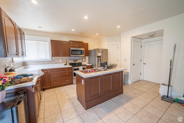 1137 S Topaz Rd, Saratoga Springs, UT 84045 - kitchen featuring appliances with stainless steel finishes, backsplash, light tile patterned floors, light countertops, and recessed lighting
