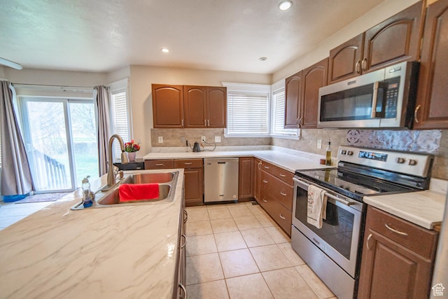 1137 S Topaz Rd, Saratoga Springs, UT 84045 - kitchen with stainless steel appliances, a sink, plenty of natural light, decorative backsplash, and recessed lighting