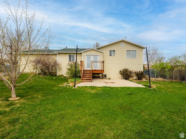 back of house with a yard, fence, and a patio area
