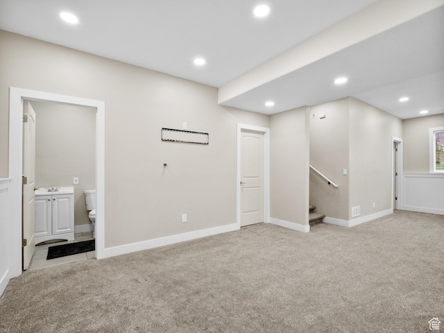 below grade area featuring stairway, baseboards, recessed lighting, and carpet