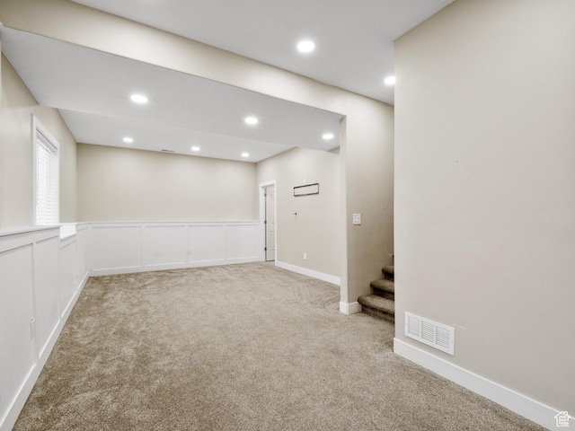 below grade area with recessed lighting, carpet, visible vents, and stairs
