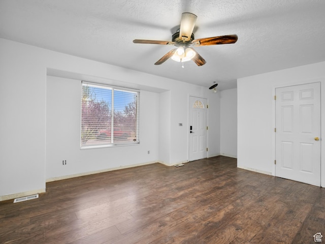 interior space with a textured ceiling, wood finished floors, visible vents, and a ceiling fan