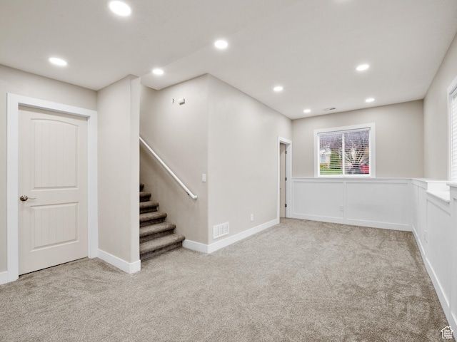 below grade area featuring recessed lighting, visible vents, and carpet