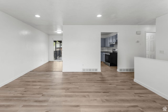 unfurnished living room with recessed lighting, light wood-type flooring, and visible vents