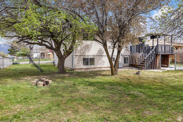 view of yard with fence, stairway, and a deck