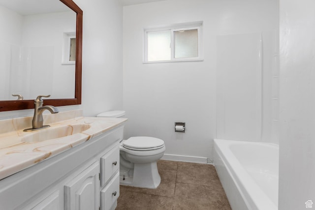 bathroom featuring toilet, vanity, tile patterned floors, and baseboards