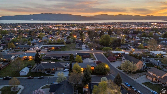 aerial view at dusk featuring a residential view and a mountain view