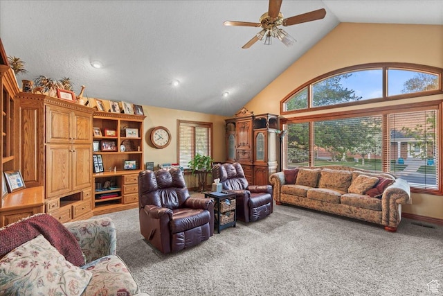 living area with visible vents, carpet floors, ceiling fan, and high vaulted ceiling