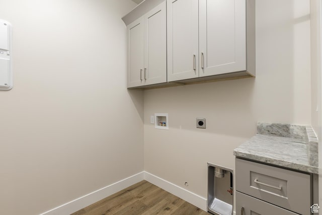 2187 W 320 S, Hurricane, UT 84737 - laundry area with hookup for a washing machine, electric dryer hookup, cabinet space, light wood finished floors, and baseboards