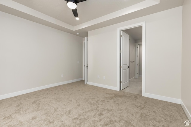 2187 W 320 S, Hurricane, UT 84737 - unfurnished bedroom with light carpet, a tray ceiling, baseboards, recessed lighting, and ceiling fan