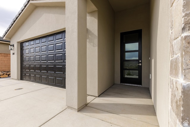 2187 W 320 S, Hurricane, UT 84737 - view of exterior entry featuring a garage and stucco siding