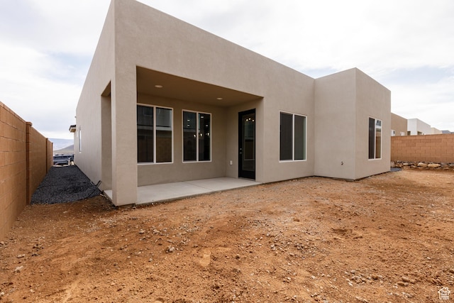 2187 W 320 S, Hurricane, UT 84737 - back of property with fence, a patio area, and stucco siding
