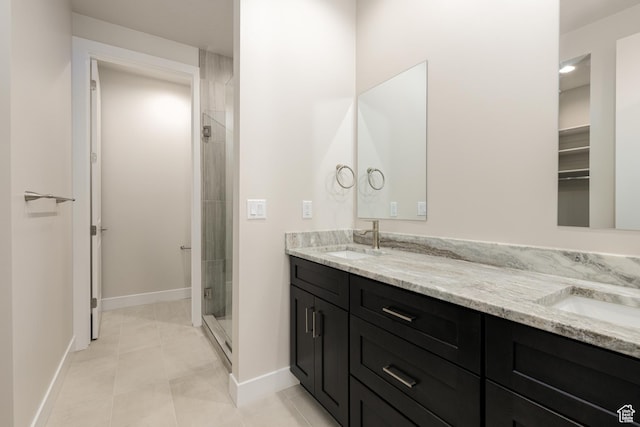 2187 W 320 S, Hurricane, UT 84737 - bathroom featuring a shower stall, baseboards, a sink, and double vanity