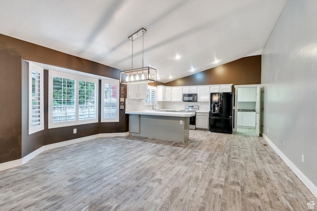 253 Ridge Rd, Orem, UT 84057 - kitchen featuring light wood-style floors, backsplash, lofted ceiling, light countertops, and black appliances