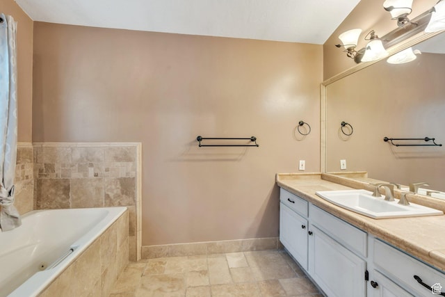 253 Ridge Rd, Orem, UT 84057 - full bathroom featuring stone finish flooring, baseboards, tiled bath, and vanity