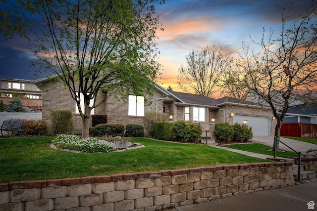253 Ridge Rd, Orem, UT 84057 - view of front of house featuring driveway, fence, brick siding, a garage, and a yard