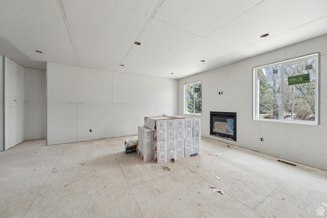 1121 Fieldstone Ct, Heber City, UT 84032 - unfurnished living room with a glass covered fireplace and visible vents