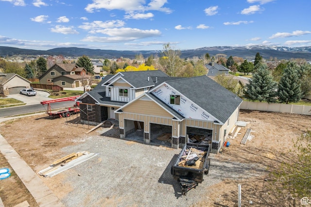 1121 Fieldstone Ct, Heber City, UT 84032 - view of front facade featuring gravel driveway, fence, an attached garage, roof with shingles, and a mountain view