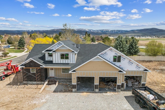 1121 Fieldstone Ct, Heber City, UT 84032 - view of front of home featuring a mountain view, roof with shingles, board and batten siding, and driveway