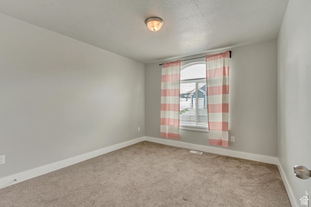 462 S 1430 E Unit 114, Tooele, UT 84074 - unfurnished room with baseboards, carpet flooring, a textured ceiling, and visible vents